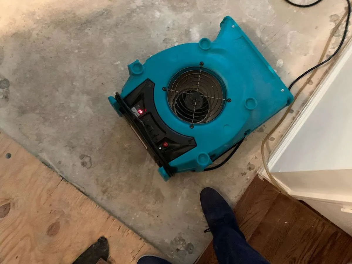 Air mover drying subfloor during Leak Detection & Repair in Iowa Park